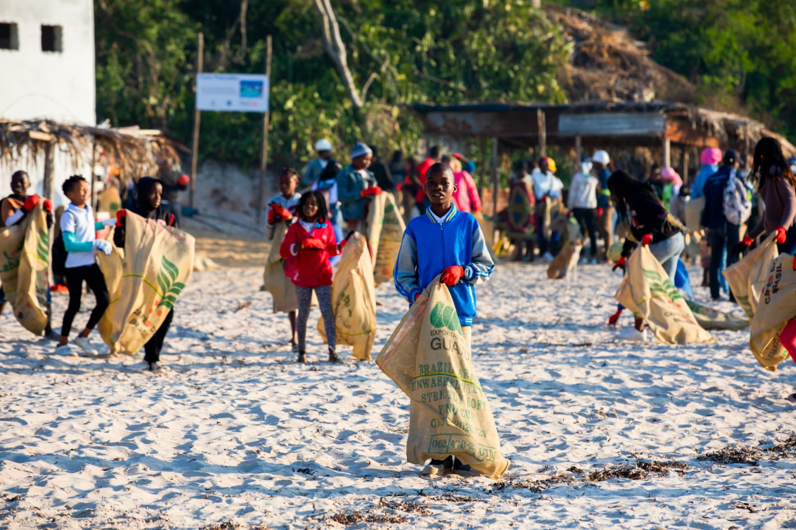 Jovens participam numa ação comunitária de limpeza da praia